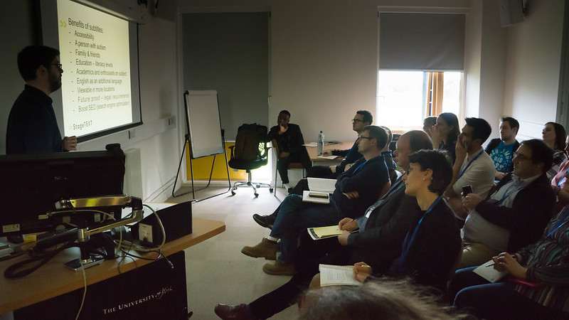 Presenter on left and audience sitting on the right