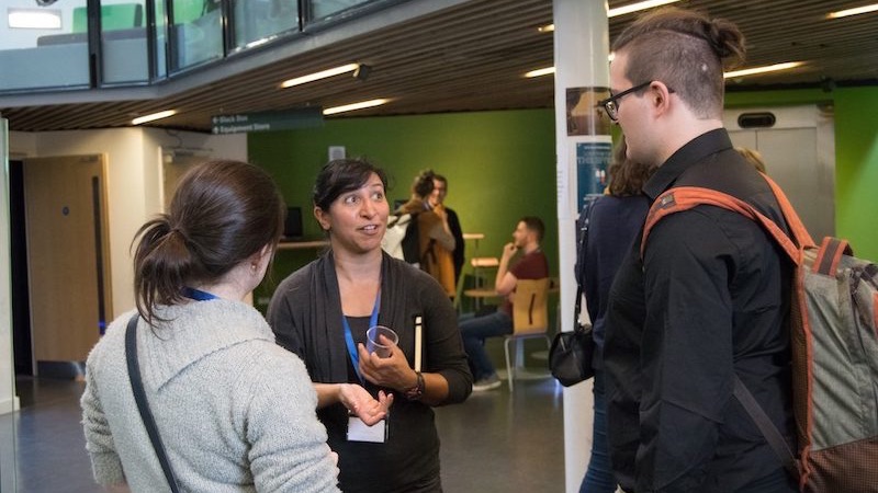 Conference attendees talking in the hallway